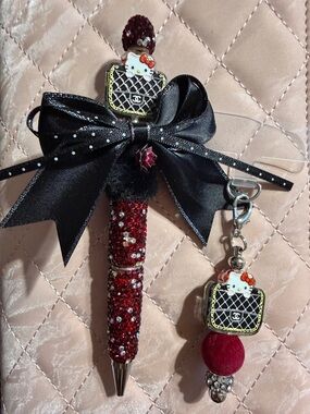 Red and black rhinestone pen with matching phone charm.